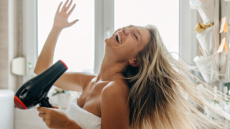 smiling woman drying hair