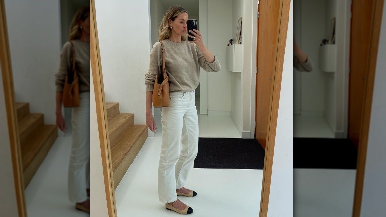 An influencer poses in a neutral, quiet luxury outfit