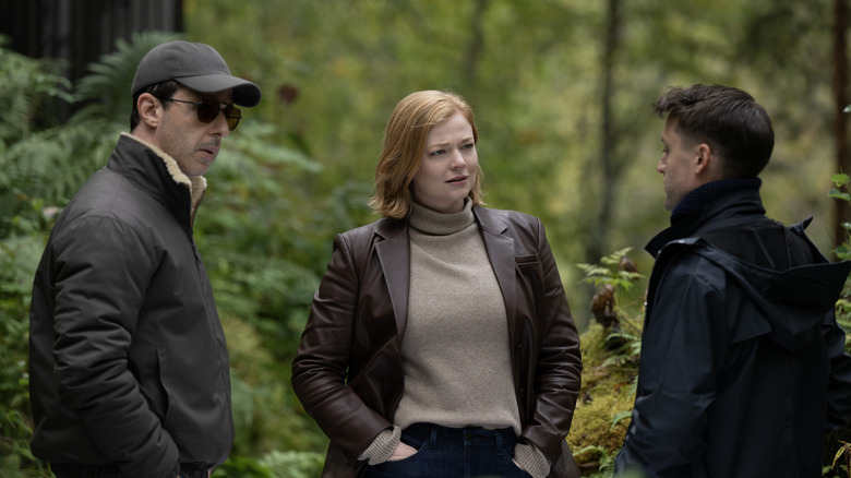Kendall, Shiv and Roman Roy talking in a forest