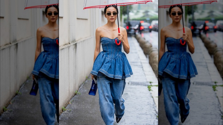 A woman wearing a denim dress and jeans 