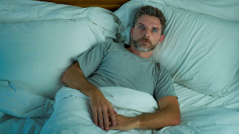 A man wide awake in bed