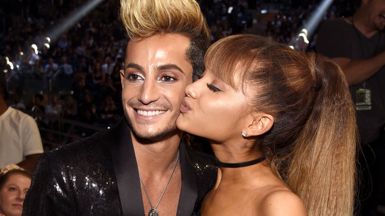Ariana Grande planting a kiss on Frankie Grande's cheek at an event