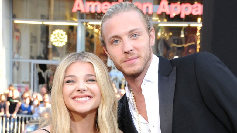 Chloë Grace Moretz and Trevor Duke-Moretz smiling together on the red carpet