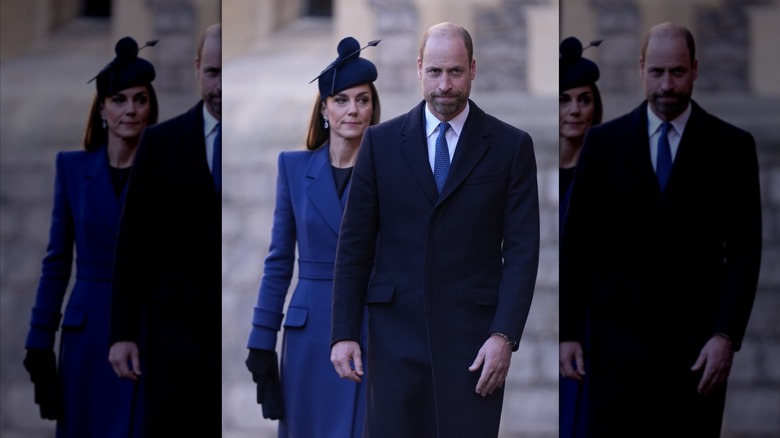 Kate Middleton in a blue coat walking behind Prince William in a navy suit