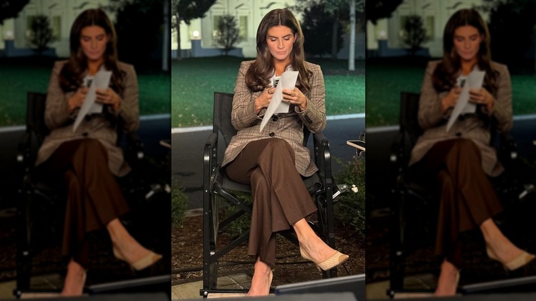 Kaitlan Collins in a brown blazer and gold signet necklace