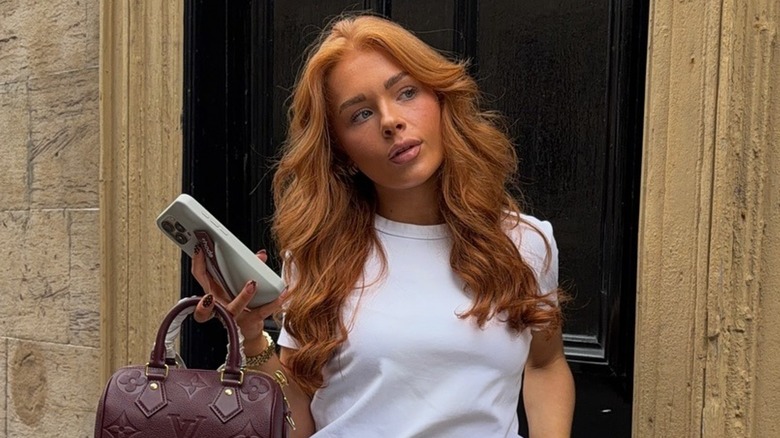 A woman with long hair and curtain bangs