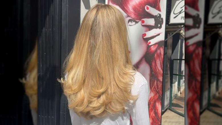 Long blonde hair with a butterfly haircut