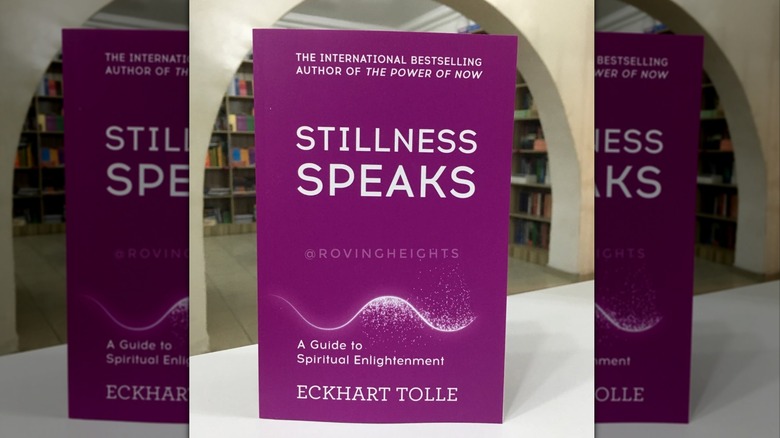 A copy of "Stillness Speaks" standing up on a white table