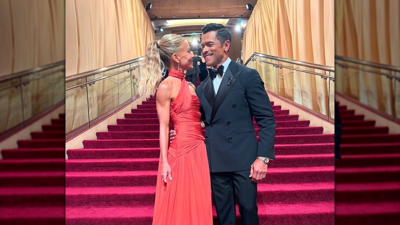 Kelly Ripa and Mark Consuelos posing for a photo together at the 2025 Oscars