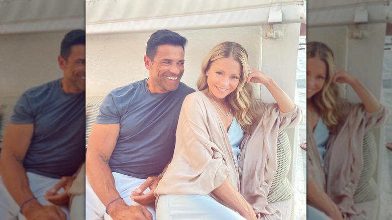 Mark Consuelos smiling at a posing Kelly Ripa on Valentine's Day in 2024