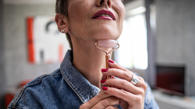 Woman using facial roller