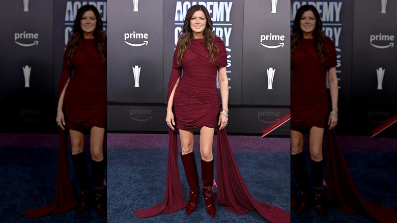 Karen Fairchild in a burgundy mini dress and knee-high boots on the 2026 ACM Awards red carpet