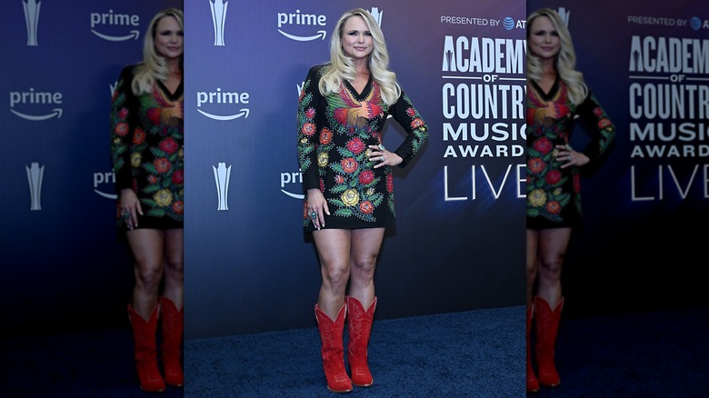 Miranda Lambert in a short, long-sleeve dress and red cowboy boots at the 2026 ACM Awards