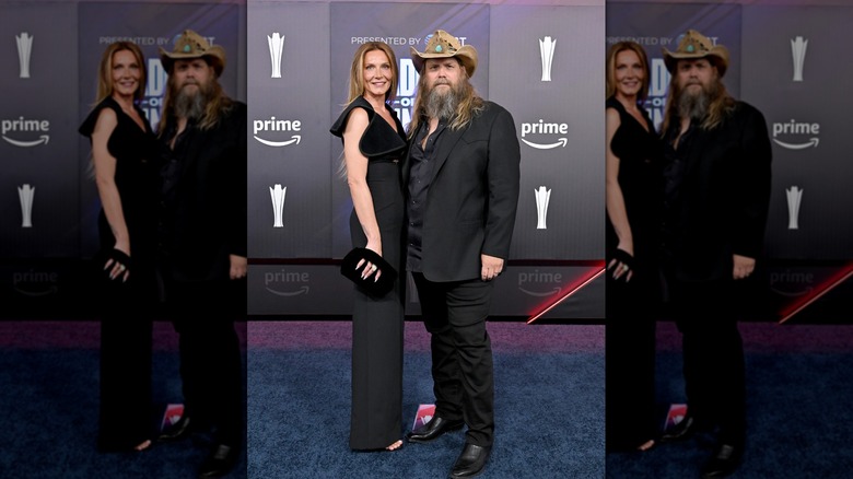 Morgane Stapleton in a long, black dress on the 2026 ACM Awards red carpet with Chris Stapleton