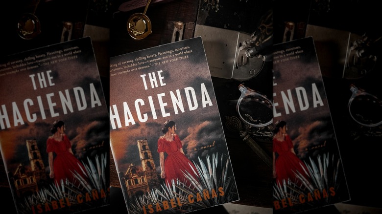 Top down view of "The Hacienda" by Isabel Cañas styled next to a vintage sewing machine, sunglasses, and other vintage-looking items