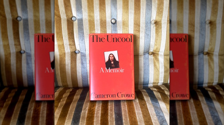 A copy of "The Uncool" sitting on a striped couch