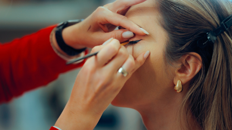Woman getting eyemakeup done