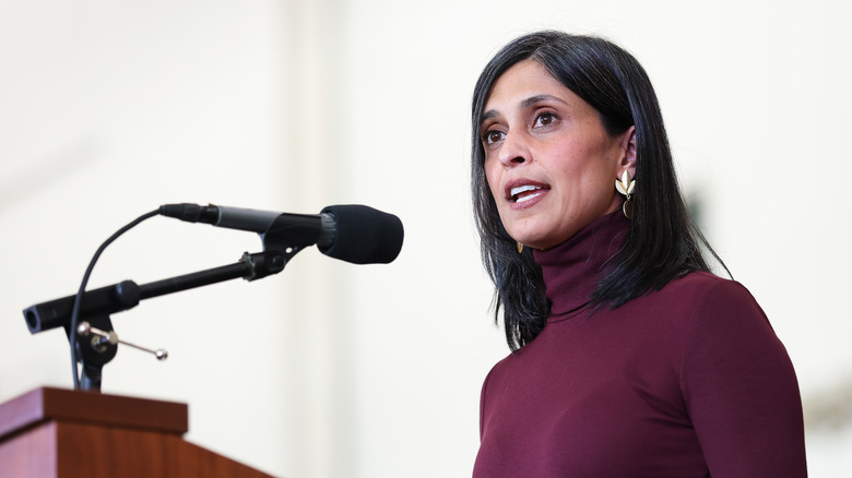 Usha Vance speaking at a podium in a burgundy dress
