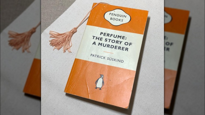 A copy of "Perfume: The Story of a Murderer" laying on a white table