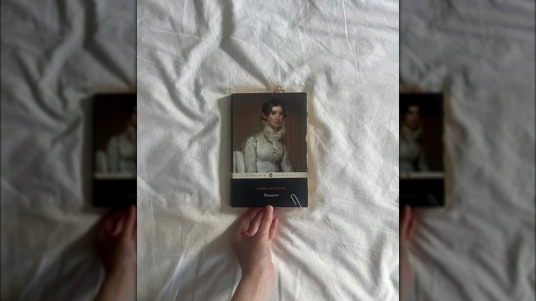 A copy of "Persuasion" laying on a bed