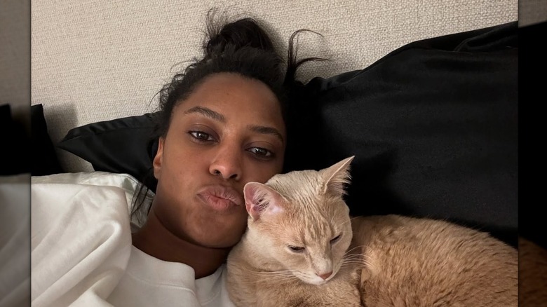 A selfie of Ciara Miller and her cat in bed at home posted to her Instagram