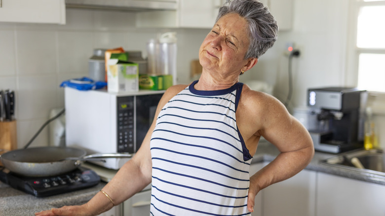 woman rubbing neck