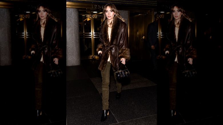Suki Waterhouse wearing heeled ankle boots and brown skinny jeans