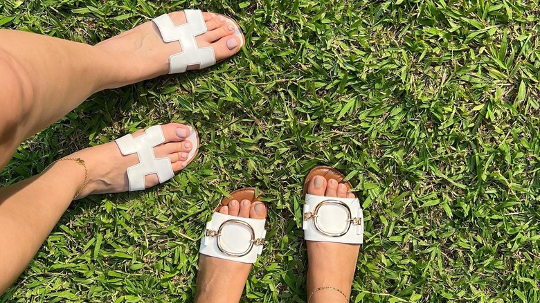 Feet in white sandals