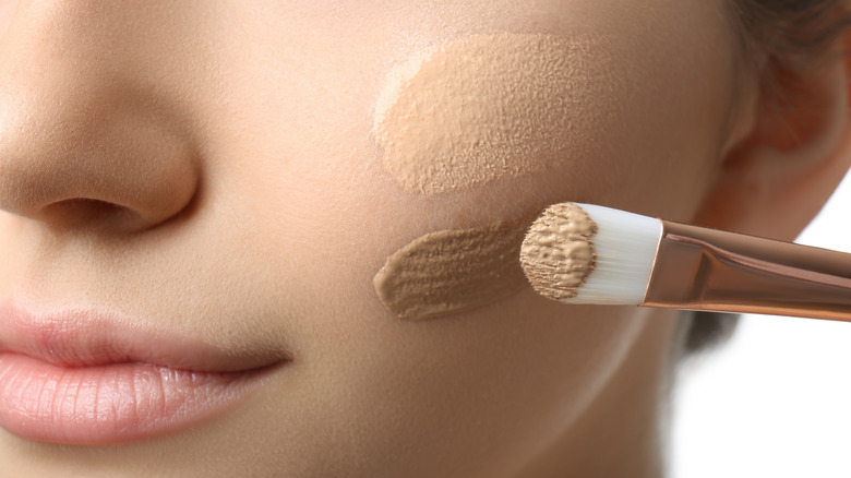 Girl applying foundation