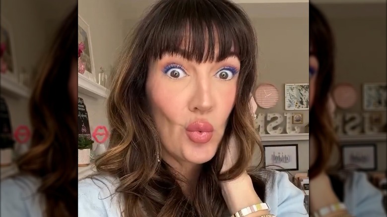 A woman wearing blue mascara