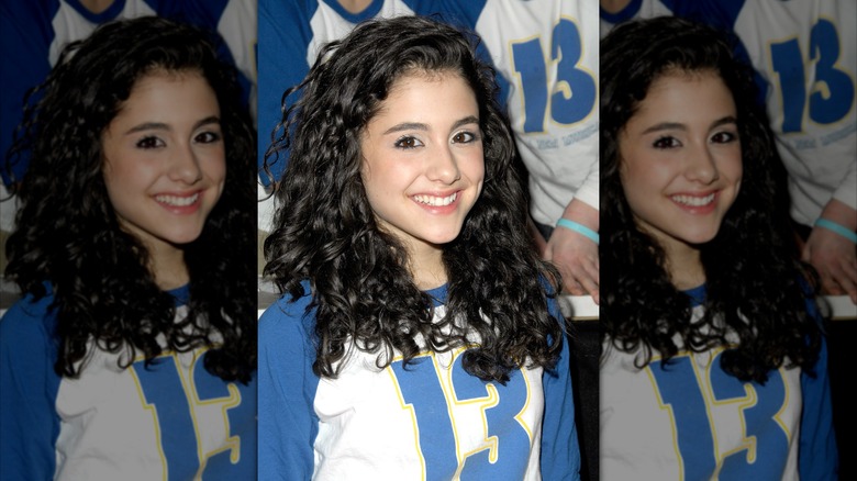 Ariana Grande with dark, curly hair smiling into the camera in 2008