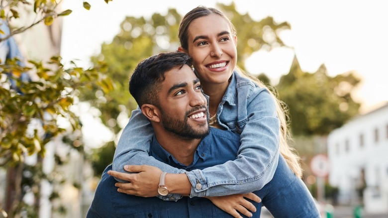 A man giving a woman a piggyback
