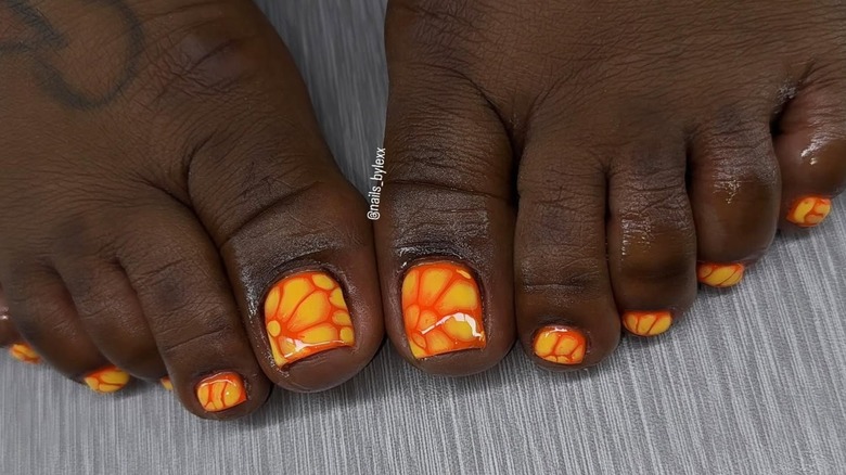 Lava lamp style nails in orange with yellow accent color