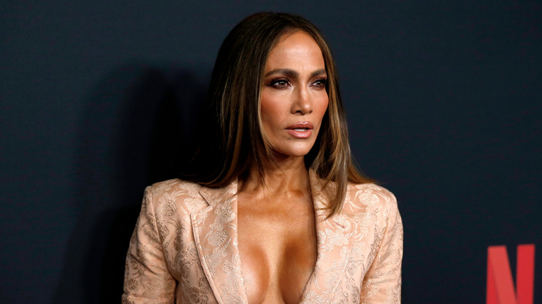 Jennifer lopez wearing a dark smoky eye and floral blazer