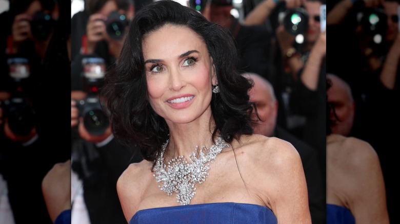 Demi Moore smiling and looking off camera at a 2026 red carpet premiere