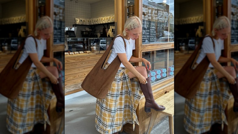 Chloe Davie wearing brown boots, a white top, and a yellow-and-brown plaid skirt