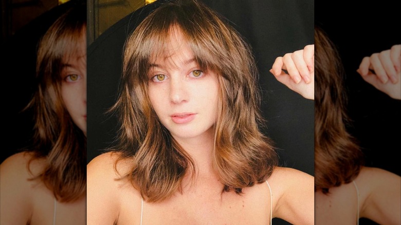 A woman with layered light brown hair