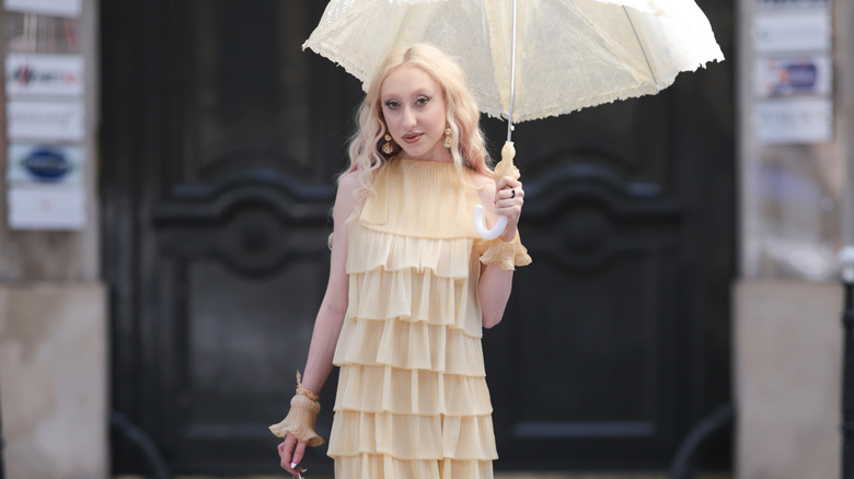 Woman wearing all butter yellow holding yellow umbrella