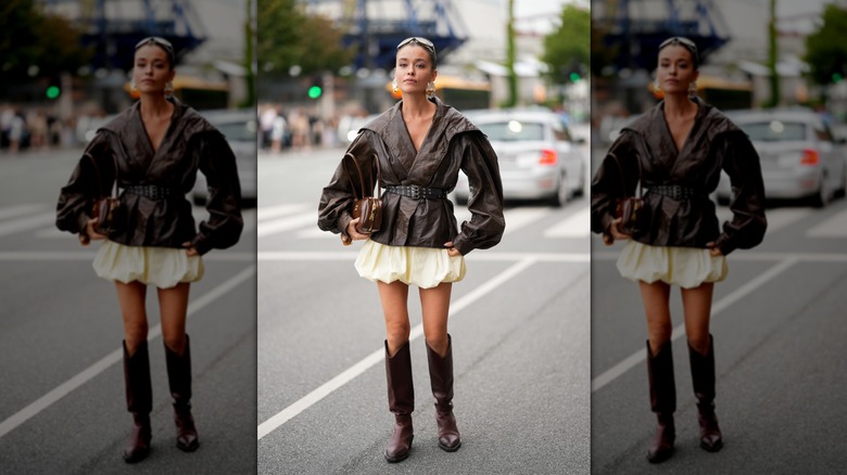 Woman in butter yellow puffball skirt and brown leather jacket