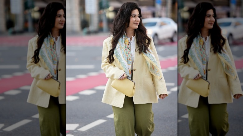 Woman in butter yellow jacket and olive green trousers