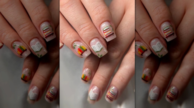 Overlapping hands showing a manicure with hand-drawn, book-related elements
