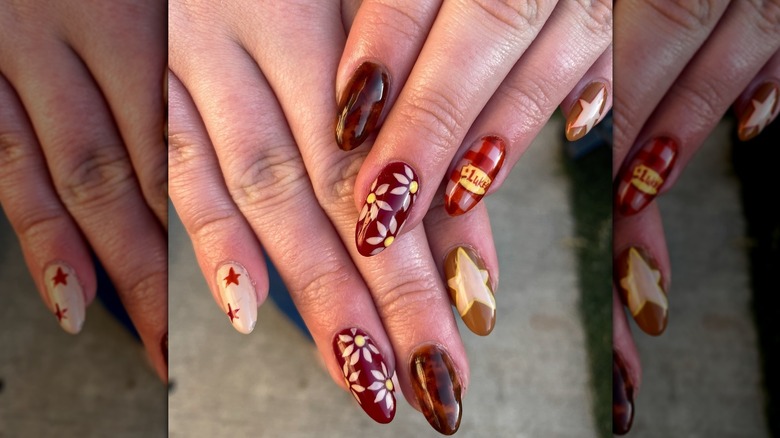 Overlapping hands showing a warm-toned, Luke's Diner-inspired manicure