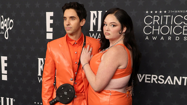 Paul W. Downs and Megan Stalter wearing matching orange outfits when attending the 31st Annual Critics Choice Awards red carpet in 2026