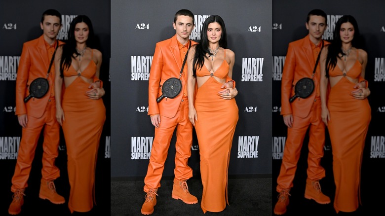 Kylie Jenner and Timothée Chalamet in matching orange outfits at the LA premiere of "Marty Supreme"