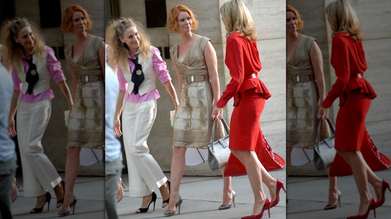 Carrie Bradshaw, Miranda Hobbes, and Samantha Jones walking down a New York street