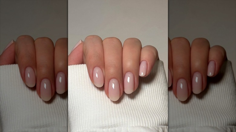 A hand with rounded pale pink nails
