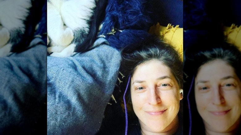 Mayim Bialik laying in bed makeup free