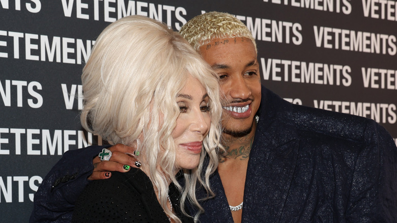 Cher has white hair as she embraces Alexander Edwards