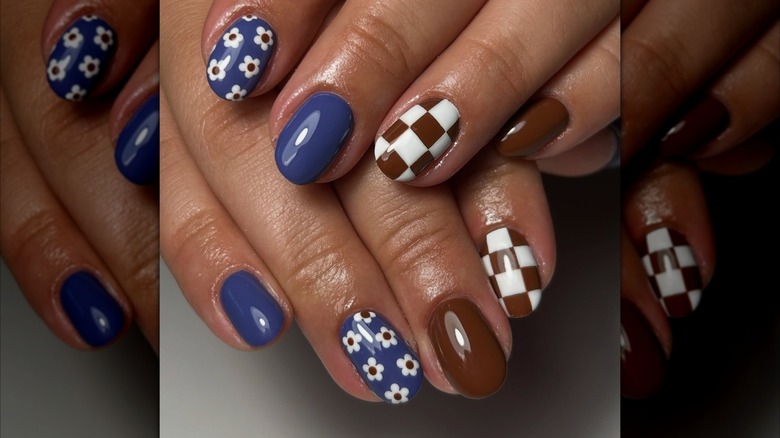Overlapping hands showing blue and brown, retro-inspired nail designs