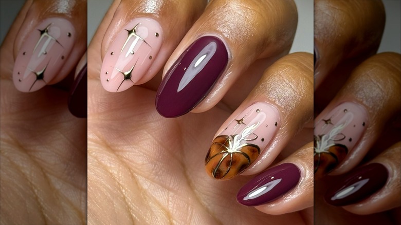 Close-up of a folded hand with a tortoiseshell pumpkin on one finger